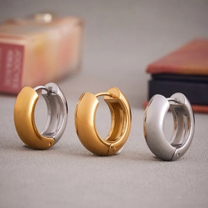 U-shaped stainless steel huggie earrings in gold, silver and two-tone polished finishes