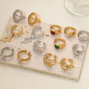 Chic gold and silver rings set featuring snake, pearl, and zircon heart motifs on stone