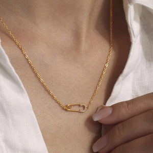 Golden paperclip safety pin necklace with micro-p镶 inlaid crystals on a gold chain