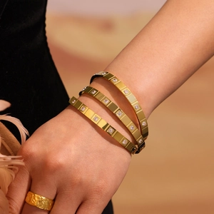 Polished 18K gold plated stainless steel bangles set with square CZ stones