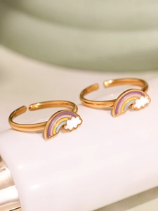 Close-up of golden adjustable rings featuring rainbow cloud drip oil enamel patterns