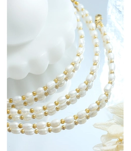 Macro shot of natural freshwater baroque pearls with gold spacer beads and lobster clasp