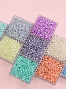 Detailed view of colorful faceted glass beads organized in a transparent grid storage box