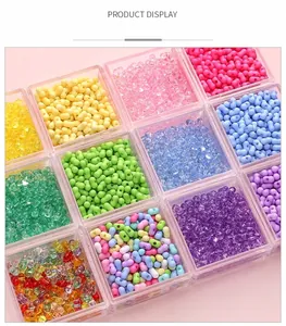 Detail of colorful peanut-shaped and round acrylic beads in a plastic storage case