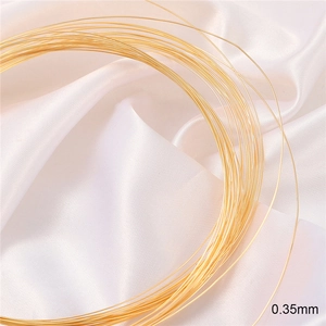 Golden 18K gold-plated 0.35mm copper wire for DIY jewelry making on white silk