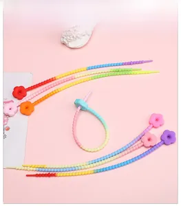 Close-up of rainbow gradient silicone flower keychains for DIY crafts and accessories