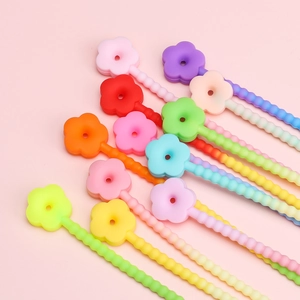 Colorful macaron silicone flower keychains and DIY pendant accessories in a neat array