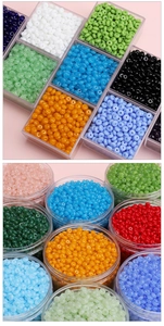 Macro shot of 6x3mm colorful glass rondelle beads in transparent storage containers
