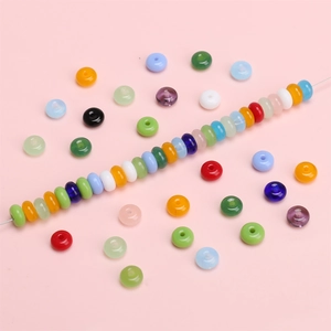 Colorful 6x3mm glass rondelle spacer beads for DIY jewelry making on pink background