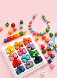 Macro detail of multi-faceted colorful wooden beads with holes for DIY jewelry making
