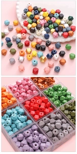 Macro view of colorful octagonal wooden beads for DIY jewelry and crafts in a sorting tray
