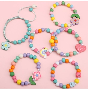 Detail of colorful 8mm wooden beads and rainbow flower pendants for DIY jewelry making