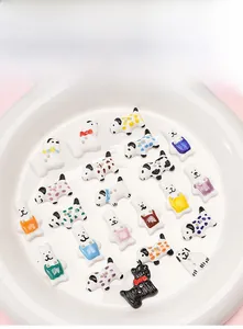 Colorful dog and rabbit ceramic beads for DIY jewelry making on white tray