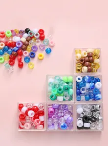 Close-up of colorful acrylic barrel beads in various finishes for DIY jewelry making