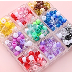 Overhead macro view of nine compartments filled with colorful acrylic DIY pony beads