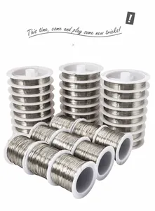 Detailed stack of 15 rolls of silver steel beading wire on white plastic spools for DIY jewelry