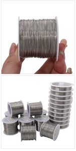 Detailed view of silver stainless steel beading wire on spools for DIY jewelry making