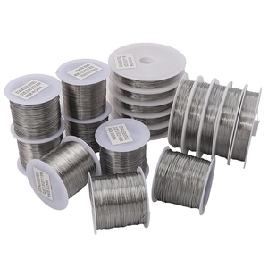 Bright silver stainless steel beading wire on white plastic spools for DIY jewelry making