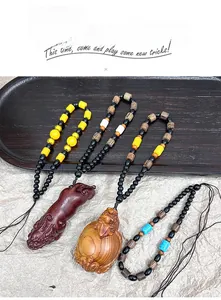 Detailed view of hand-woven cords with carved wooden lucky beast pendants and beads