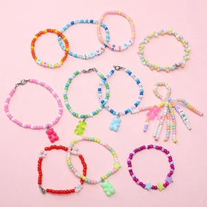 Detail of DIY jewelry kit featuring macaron rainbow beads and gummy bear pendants