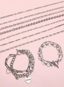 Close-up of stainless steel twisted chains and bracelets with heart pendants and OT clasps