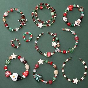 Flat lay of Christmas DIY jewelry kit with snowman, tree beads and festive charms