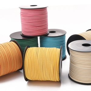 Close-up of colorful 3mm faux suede cord spools for DIY jewelry making and crafts