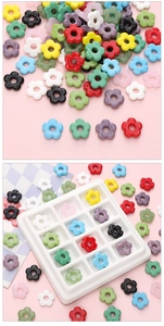 Colorful floral resin spacer beads for DIY jewelry making displayed on a pink surface