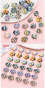 Macro shot of colorful hand-painted ceramic tropical fish beads for DIY jewelry making