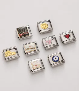 Macro view of eight stainless steel Italian charm links with enamel and laser cut details
