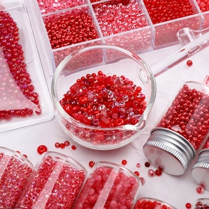 Red glass seed bead set for DIY jewelry making in various containers and bottles