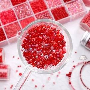 Macro shot of assorted red glass seed beads and faceted crystals for DIY jewelry making