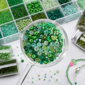 Macro shot of assorted green DIY glass beads in a spoon for jewelry making