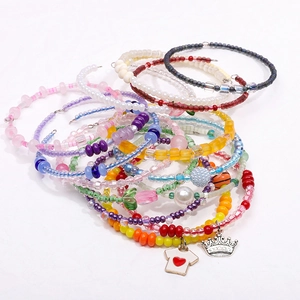 Macro view of colorful DIY bead bracelets with mixed resin charms and glass seed beads