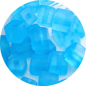 Pile of matte blue square glass seed beads with center holes for DIY jewelry making