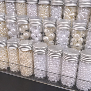 Detailed display of ABS pearl beads in clear jars with silver lids for DIY jewelry