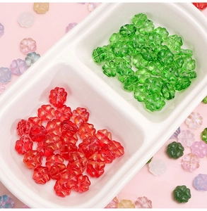 Macro shot of colorful glass four-leaf clover beads for DIY jewelry and hair accessories