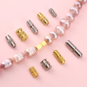 Golden and silver screw clasps for DIY jewelry making shown with pink pearls