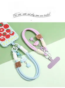 Close-up of woven polyester phone lanyards with cloud, star charms and leather smiley detail