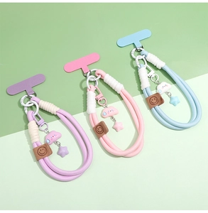 Detail of woven phone wrist straps with cloud and star charms plus secure connector pads