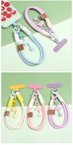 Detail of colorful woven polyester phone lanyard with star charms and smiling face leather patch