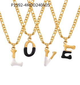Detailed view of four Figaro chains with gold-tone metal and black-white enamel LOVE pendants