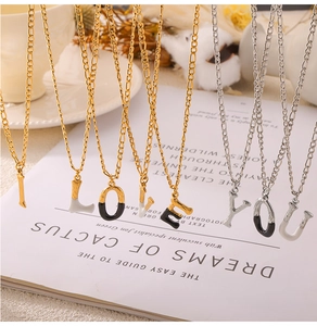 Detailed view of titanium steel necklaces with I LOVE YOU letter pendants in gold and silver