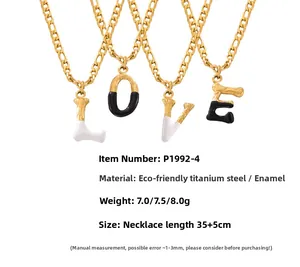 Detail of LOVE letter pendants in titanium steel with gold texture and colorful enamel