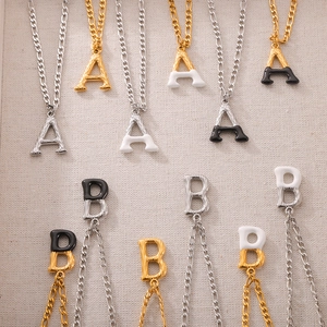 Minimalist gold and silver titanium steel letter necklace with tree bark texture finish