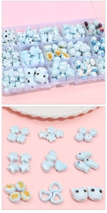 Detailed view of assorted light blue ceramic beads in various shapes for DIY jewelry making