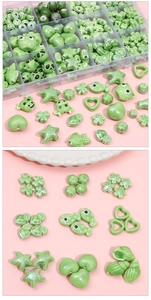Detailed view of assorted green ceramic beads in heart, star and floral shapes for DIY crafts