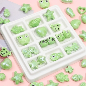 Mix of light green ceramic beads in panda, heart and clover shapes for DIY jewelry making