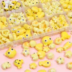 DIY yellow ceramic bead set with heart, star and flower shapes in a storage box