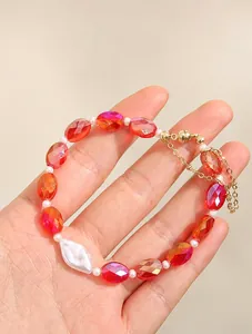 Detail of red faceted crystal beads and white pearls bracelet with a magnetic clasp